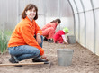 family works in greenhouse family works in greenhouse