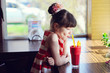 Child girl drinking strawberry smoothie