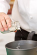 chef seasoning meal with fresh sea salt