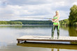 fishing woman standing on pier fishing woman standing on pier