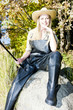 fisher woman sitting on stone