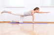 Photo: Woman doing stretching yoga exercise at sport gym Woman doing stretching yoga exercise at sport gym