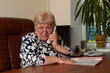 senior at workplace with phone