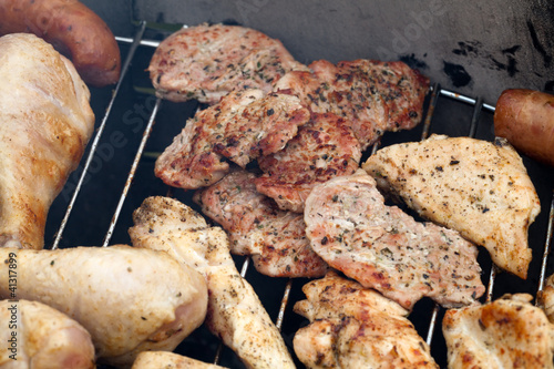 Photo: barbecue with delicious grilled meat on grill barbecue with delicious grilled meat on grill
