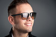 Photo: Young boy with sunglasses against grey background. Young boy with sunglasses against grey background.