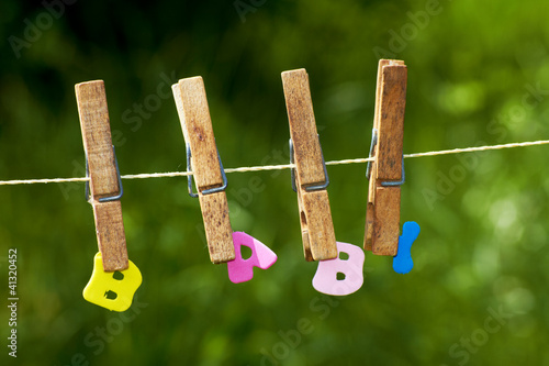 Photo: the word baby with clothes-peg on a washine line the word baby with clothes-peg on a washine line