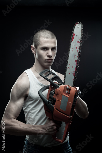 Photo: Maniac with chainsaw Maniac with chainsaw
