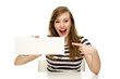 Excited woman pointing at blank sign Excited woman pointing at blank sign