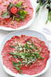 Carpaccio with arugula and cheese