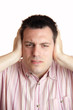 Man shielding his ears with hands
