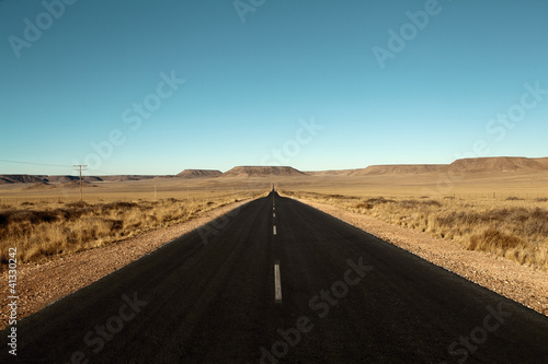 Foto Murales paved road in the desert
