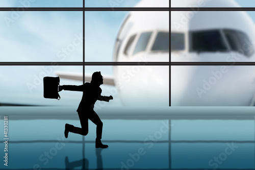 Photo: Businessman rushing in the airport Businessman rushing in the airport