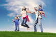 Happy Asian Family in Meadow