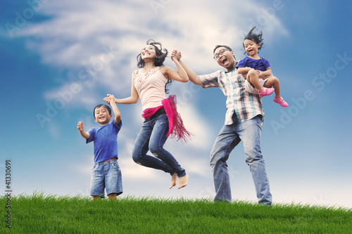 Photo: Happy Asian Family in Meadow Happy Asian Family in Meadow