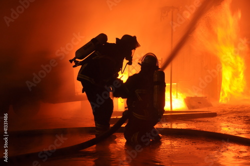Photo: Feuerwehr vor Flammenwand Feuerwehr vor Flammenwand
