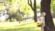 Girl with basket of flowers near the tree