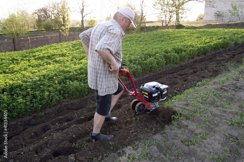 Photo: The farmer with a motor-cultivator The farmer with a motor-cultivator