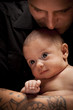 Young Father Holding His Mixed Race Newborn Baby