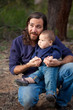 Father and son having fun in the forest Father and son having fun in the forest