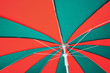 Under red and green umbrella