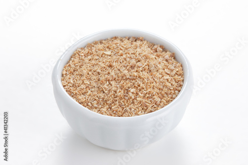 Photo: Coriander ground (Coriandrum sativum) in a white bowl on white b Coriander ground (Coriandrum sativum) in a white bowl on white b