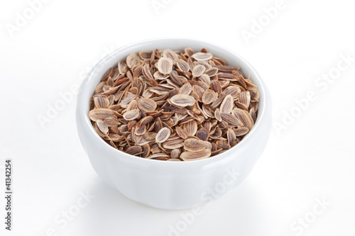Photo: Fennel seeds (Anethum graveolens) in a white bowl on white backg Fennel seeds (Anethum graveolens) in a white bowl on white backg