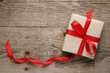 Gift box with bow on wooden background