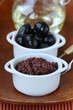 appetizer of olives, tapenade on a wooden board