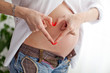 Pregnant woman making a heart