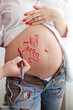 Drawing on a pregnant woman's belly Drawing on a pregnant woman's belly