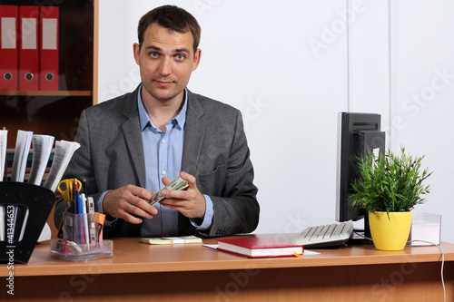 Photo: Man with money showing thumbs up Man with money showing thumbs up