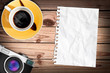 blank paper on wood table with a cub of coffee and classic camer blank paper on wood table with a cub of coffee and classic camer
