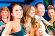 People in club or bar drinking champagne