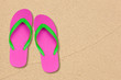 pink and green flip flops on the beach with space pink and green flip flops on the beach with space