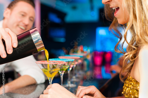 Photo: People in club or bar drinking cocktails People in club or bar drinking cocktails