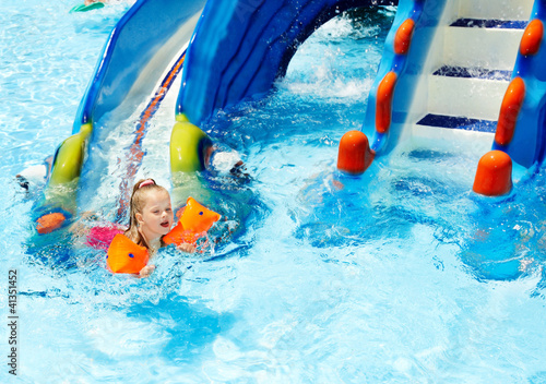 Photo: Child with armbands in swimming pool. Child with armbands in swimming pool.