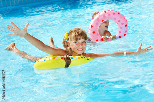 Photo: Children sitting on inflatable ring. Children sitting on inflatable ring.