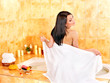 Woman relaxing in bathroom.