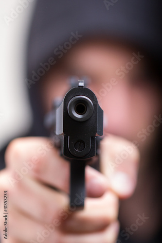 Photo: Man with gun, gangster, focus on the gun Man with gun, gangster, focus on the gun