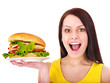 Woman holding hamburger.