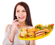 Thin woman holding hamburger.