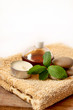 spa candle, oil and mint soap placed on a towel spa candle, oil and mint soap placed on a towel