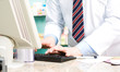 Pharmacist typing at computer