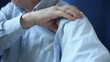 man rubbing sore shoulder