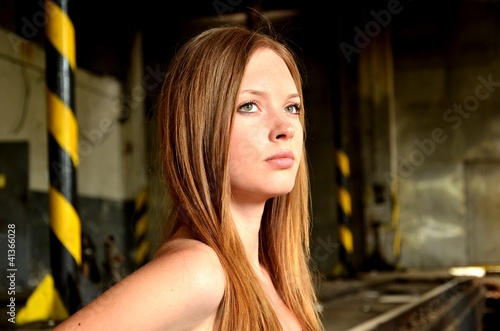 Photo: woman posing in ruins of old factory woman posing in ruins of old factory
