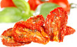 sun-dried tomatoes with basil leaves and tomato on background, o