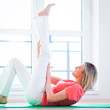Foto: Pretty young woman doing YOGA exercise at home Pretty young woman doing YOGA exercise at home