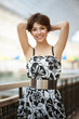 young woman stands near railing