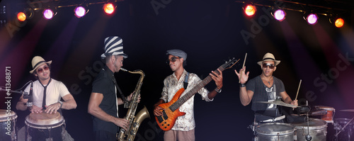 Photo: Four musicians performing isolated over back Four musicians performing isolated over back