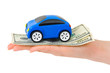 Hand with money and toy car